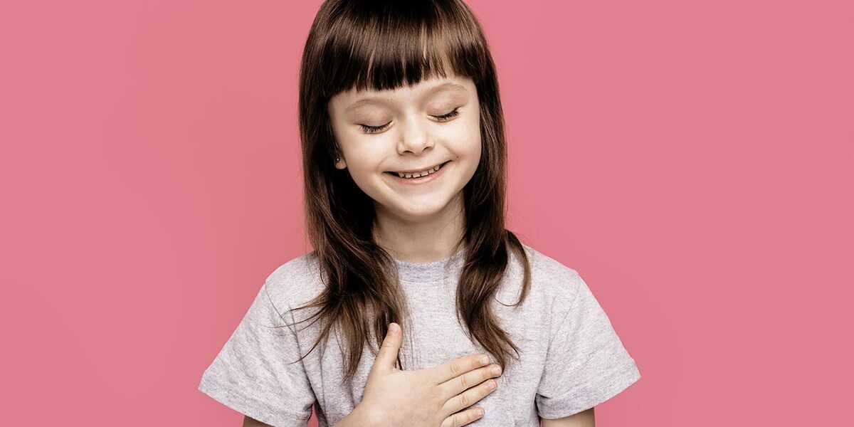 A pink background and a girl laughing