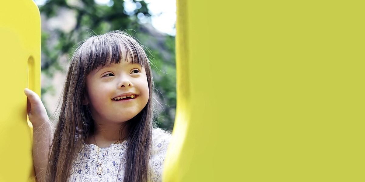 A girl smiling and playing outside